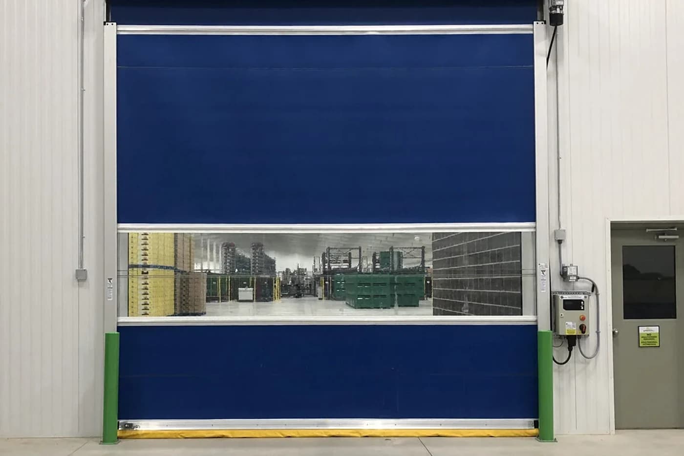 High-speed roll-up commercial door at a Canadian distribution-warehouse opening