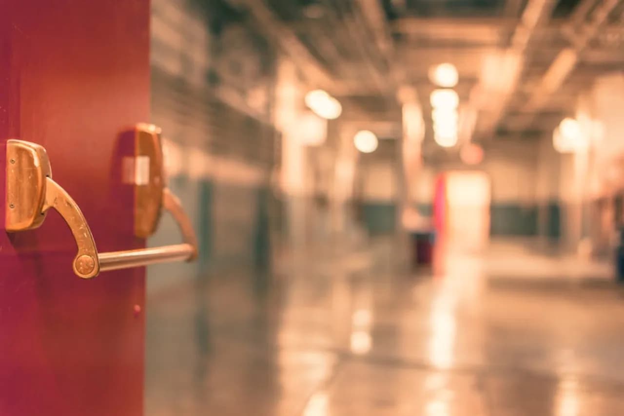 Painted hollow-metal commercial door in a Canadian institutional building corridor